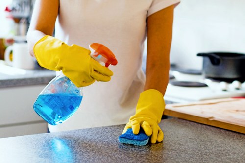 Technician using approved cleaning products with care